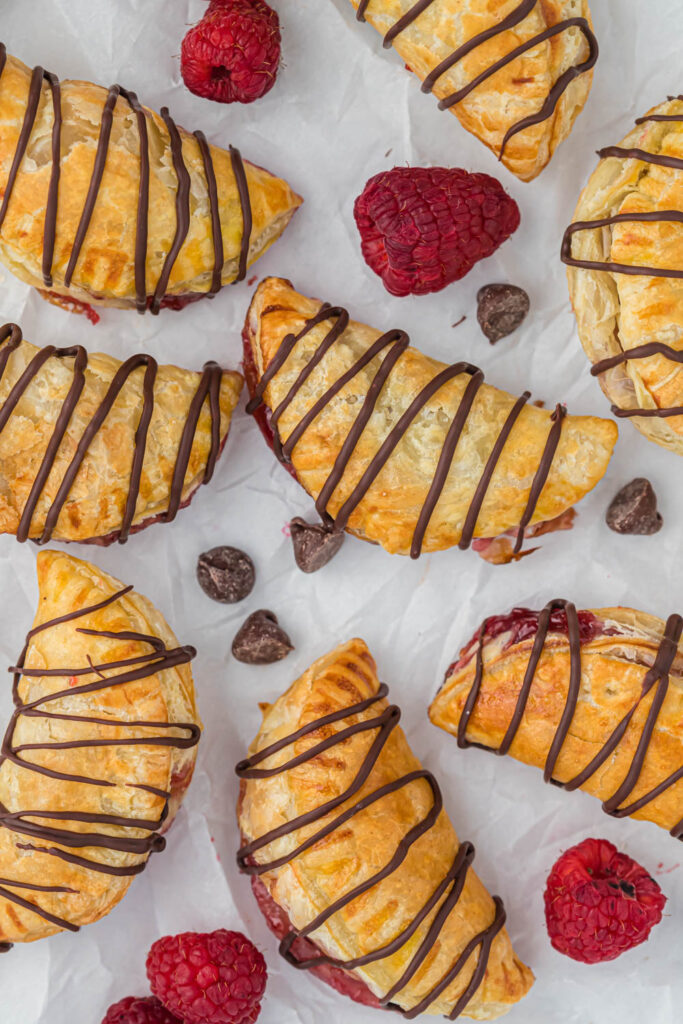 Raspberry Chocolate Hand Pies on white parchment paper.