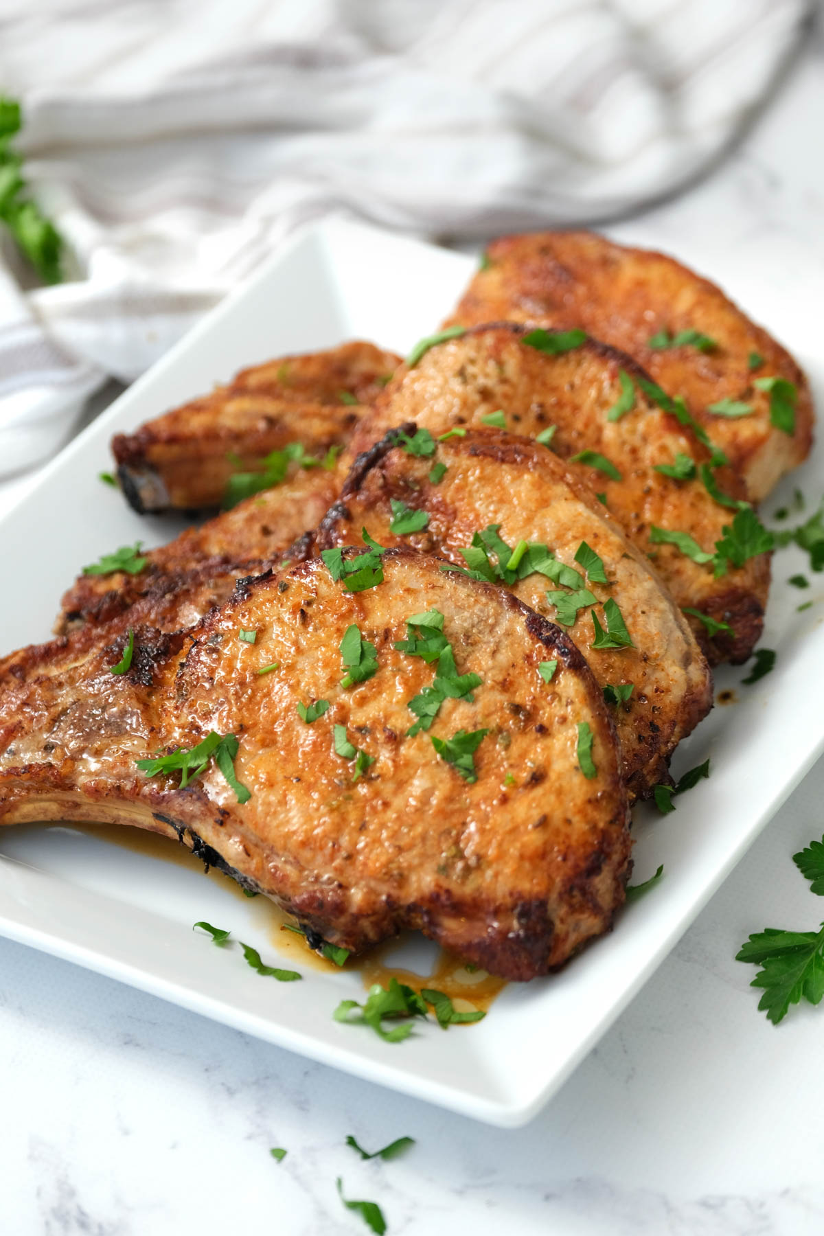 cooked pork chops on white plate.