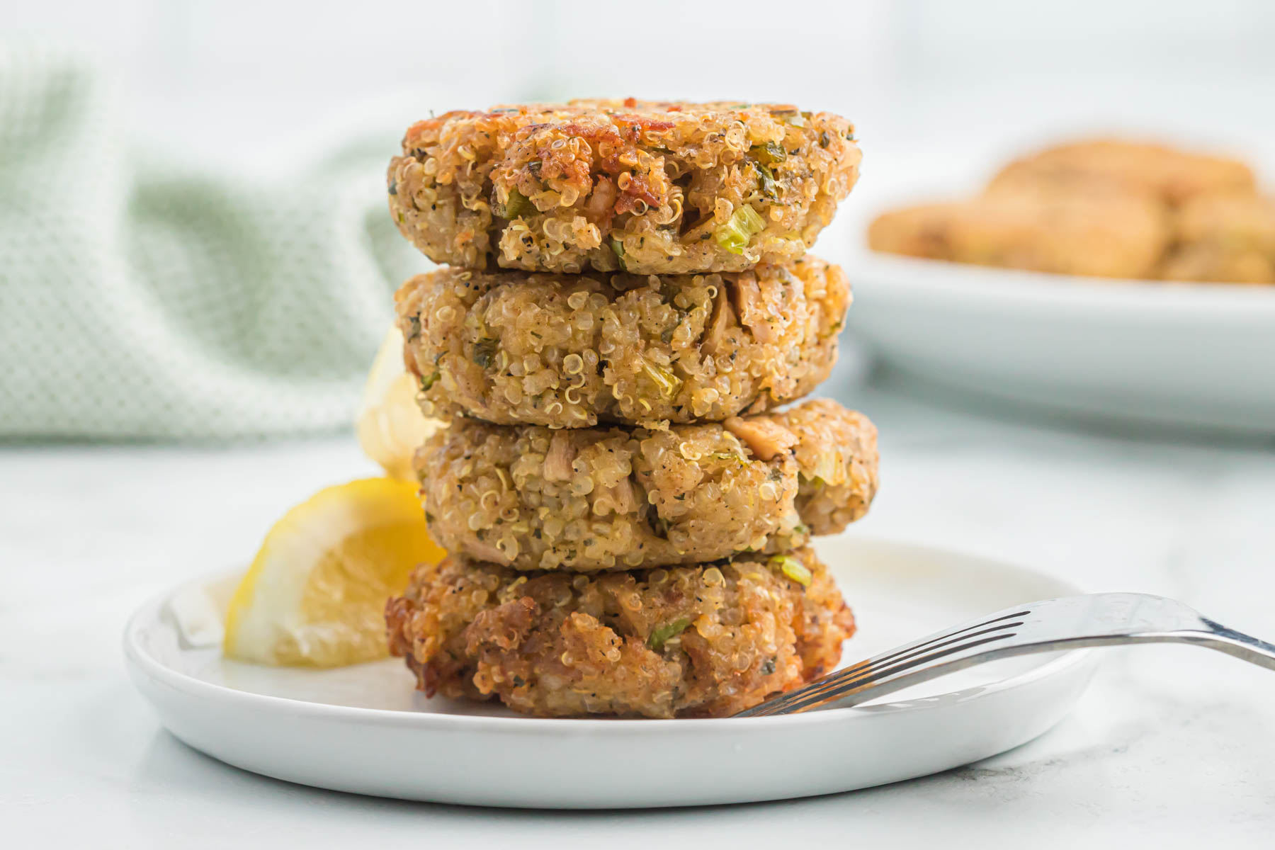 tuna cakes on white plate with fork.