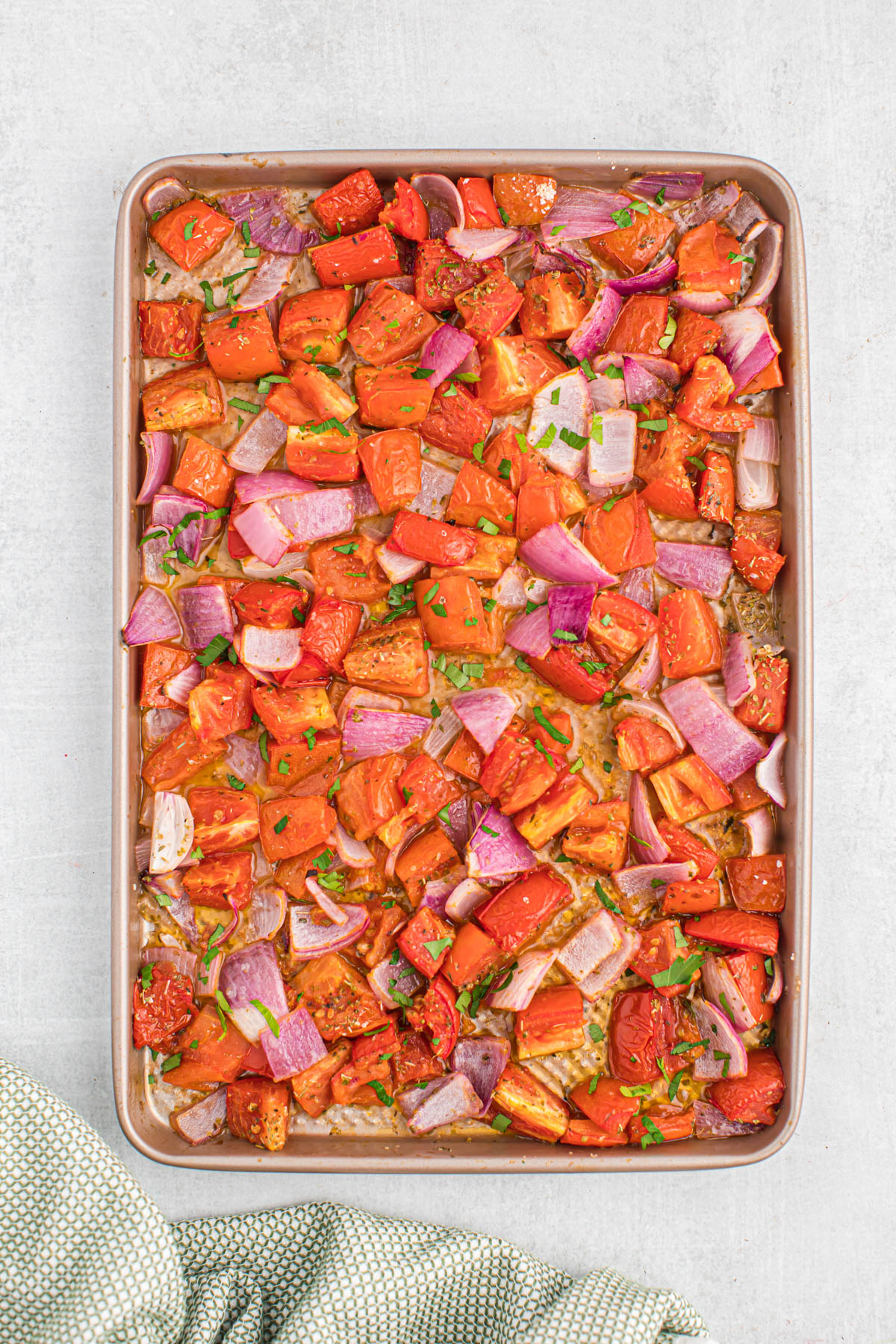 overhead view of roasted tomatoes on sheet pan