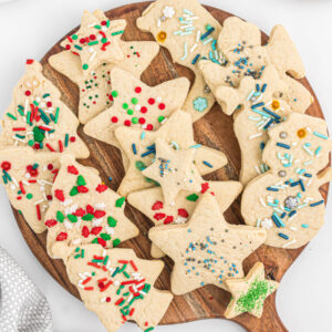 cut out cream cookies on wooden board