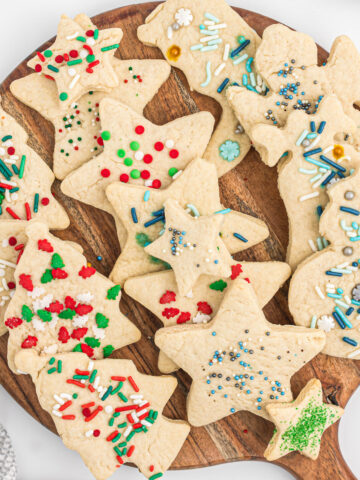 cut out cream cookies on wooden board