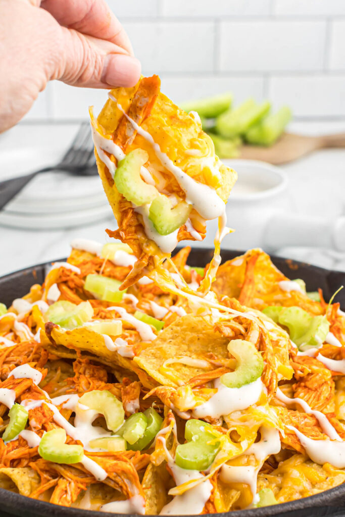 cheese pull of buffalo chicken skillet nachos