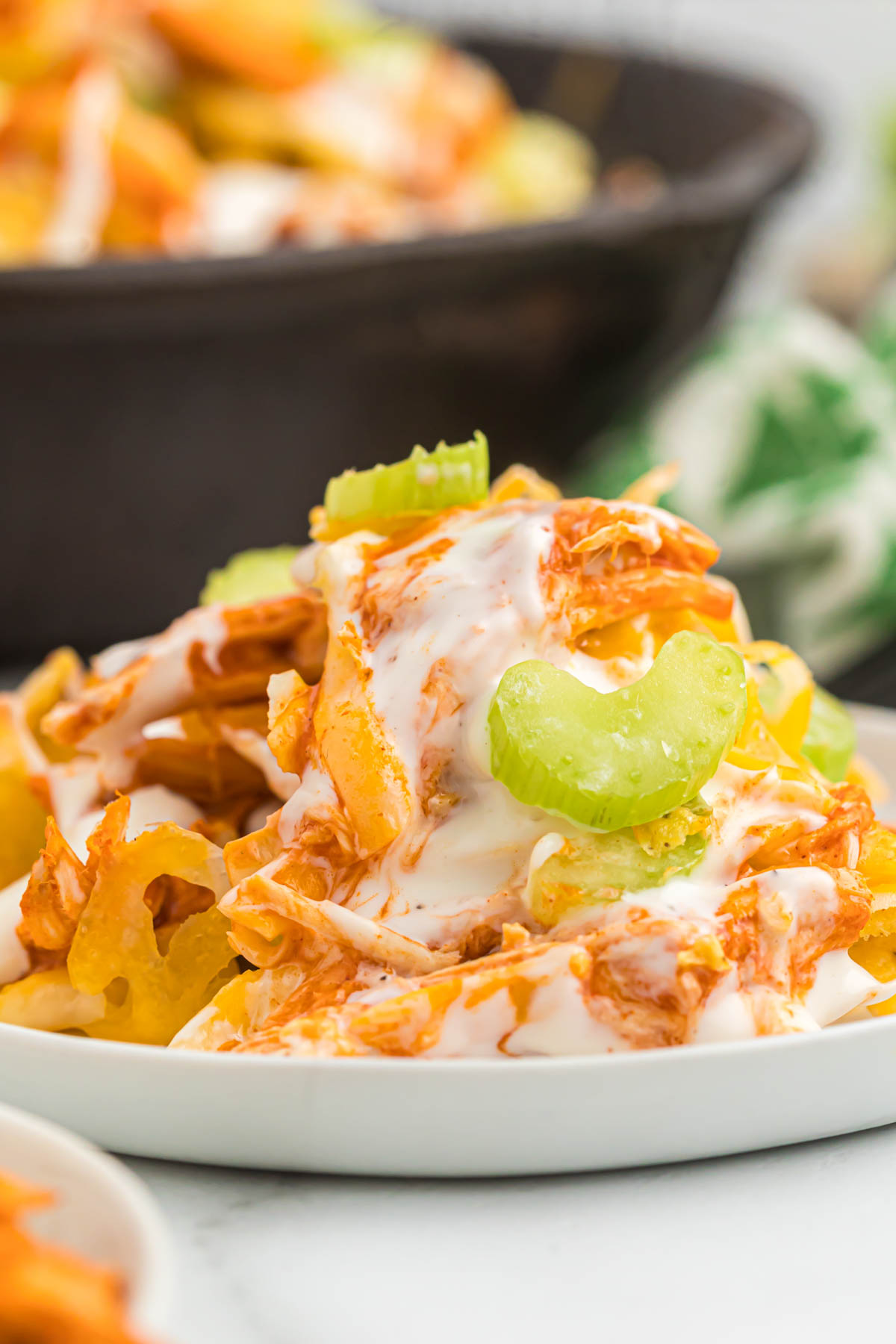 nachos topped with ranch and celery