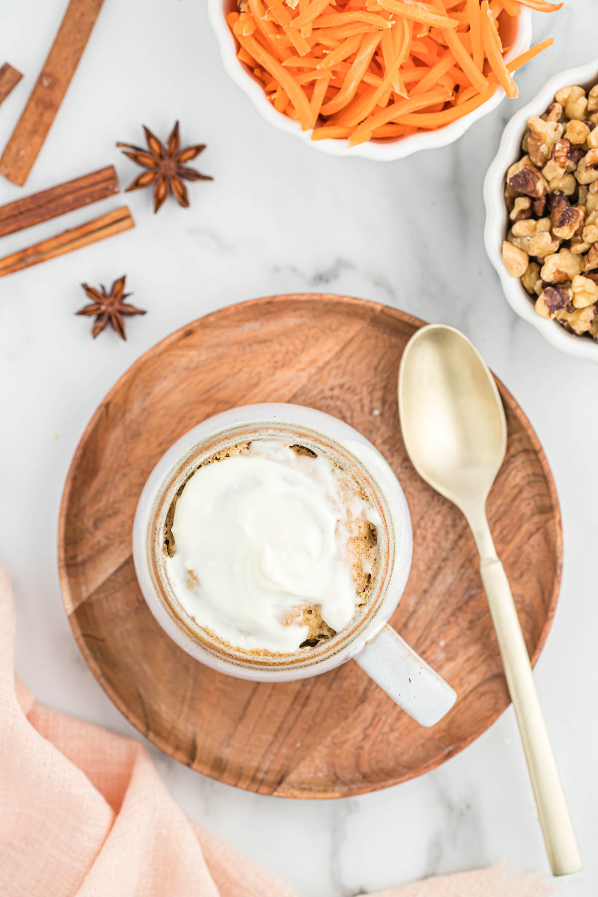 overhead view of mug cake topped with cream cheese icing