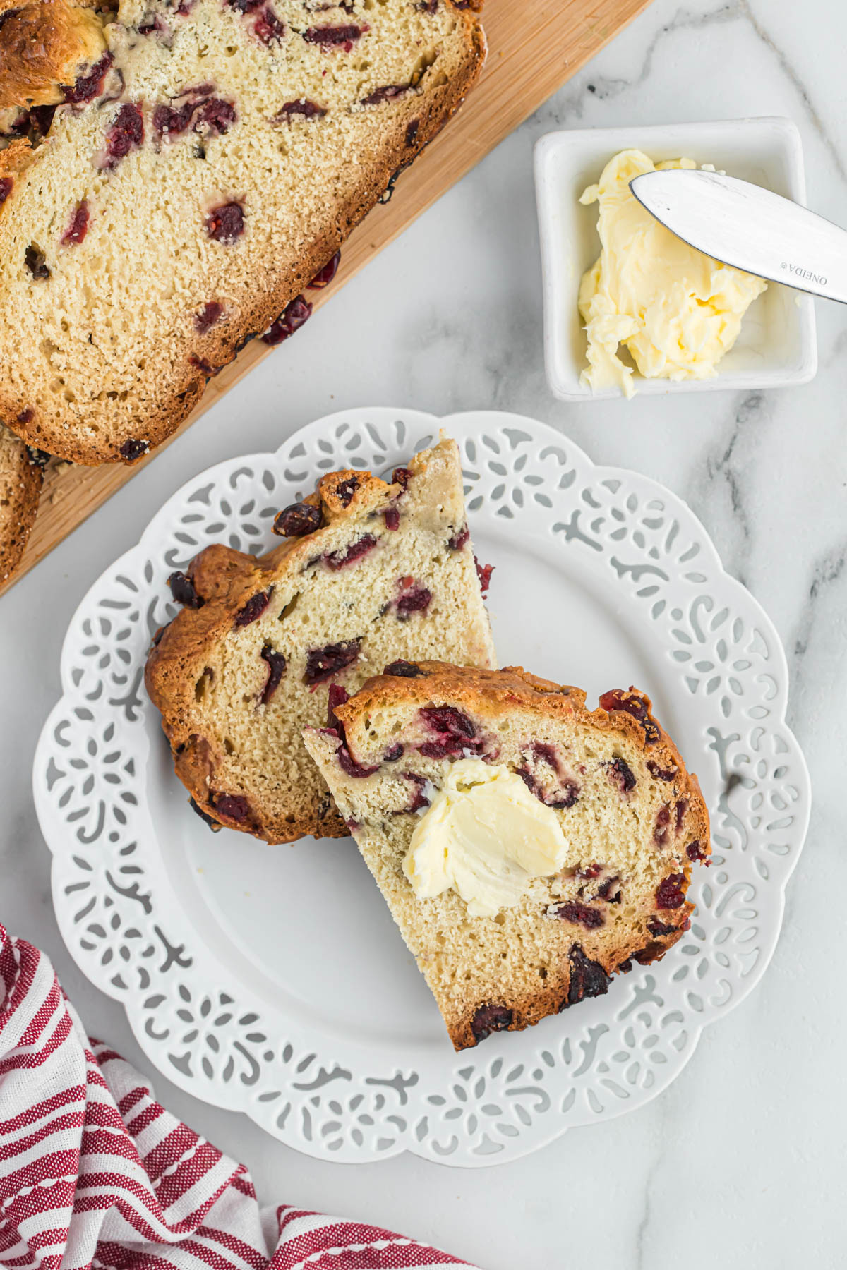 cut pieces of soda bread on white plate with butter