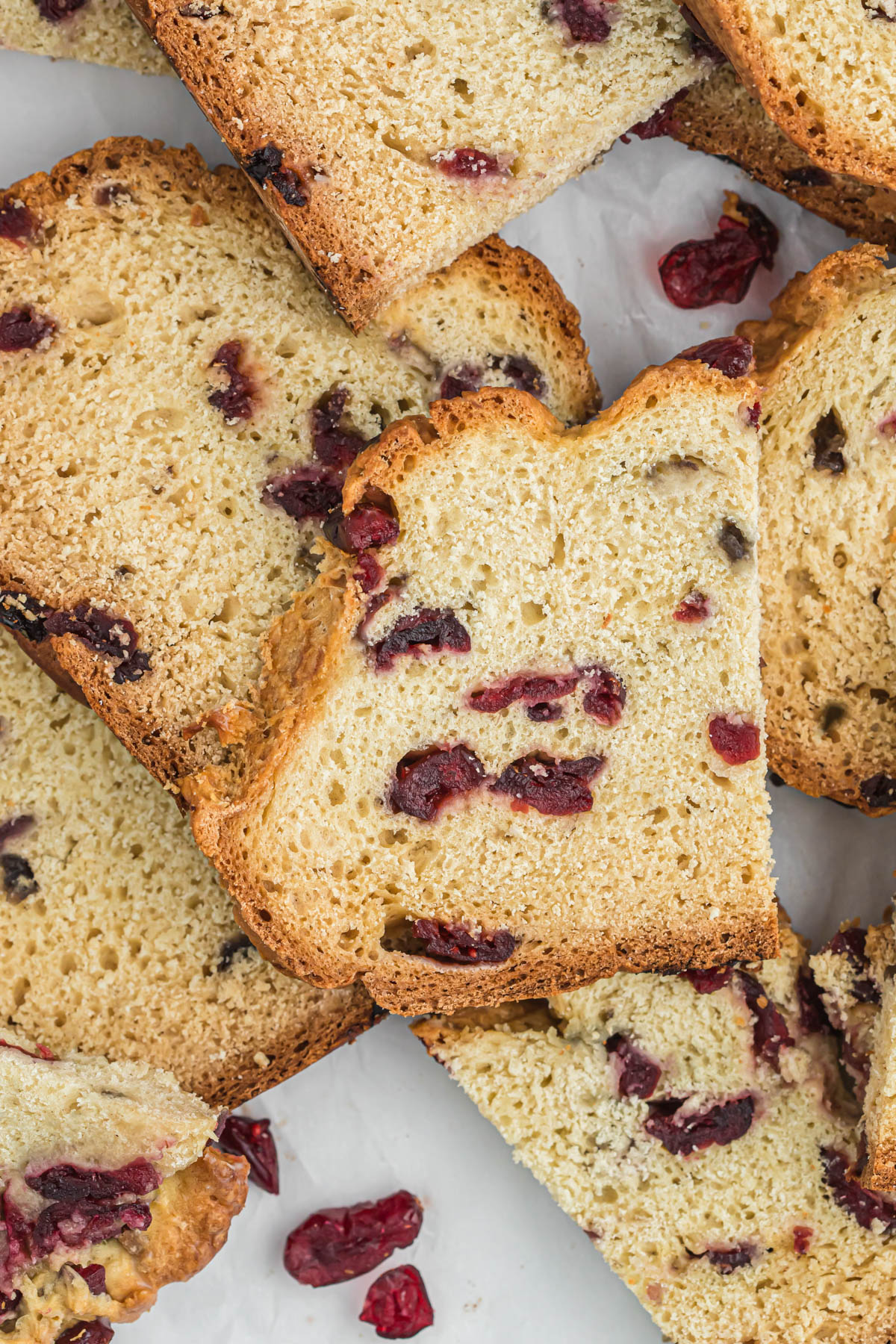 slices of cranberry soda bread on white background