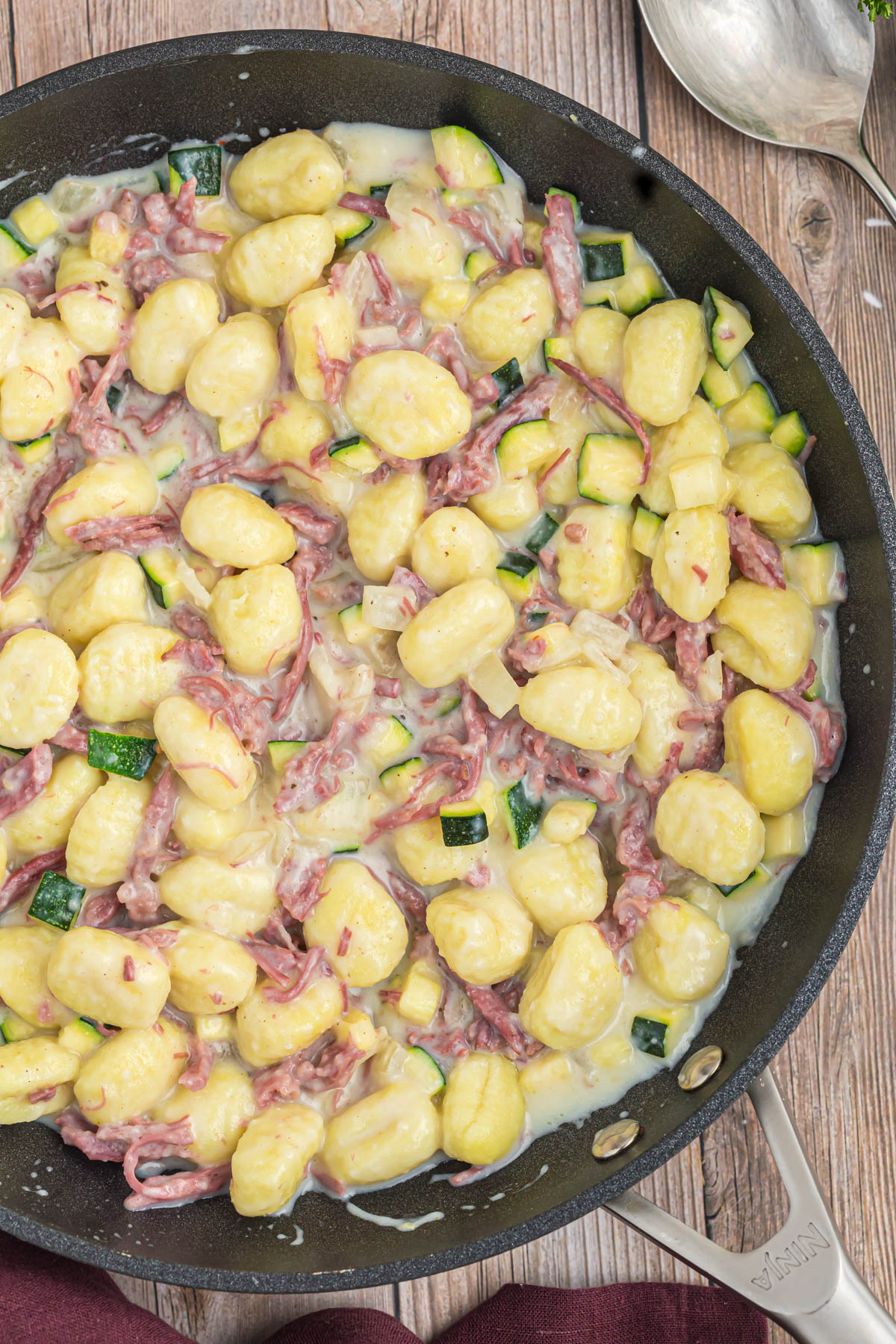 Creamy Gnocchi with Corned Beef in skillet.