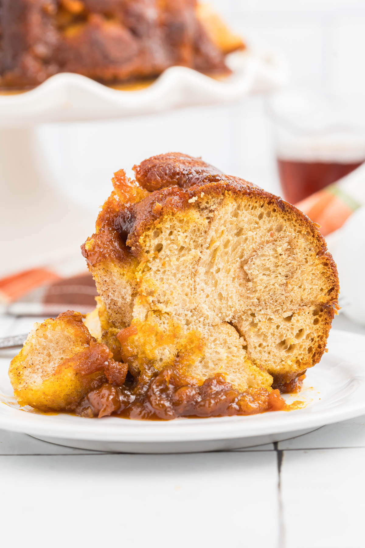 slice of maple pumpkin monkey bread on white plate.