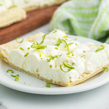 A serving of key lime tart on white plate.